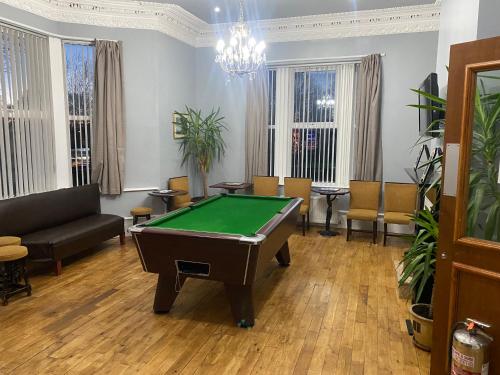 a living room with a pool table in it at The Clifton Hotel Newcastle in Newcastle upon Tyne