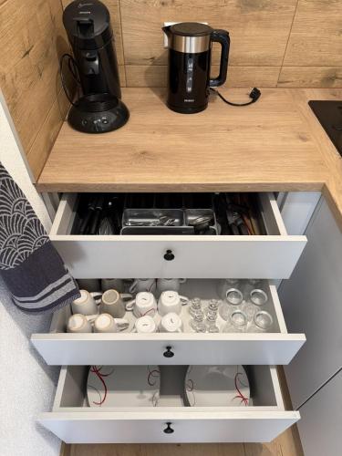 a drawer in a kitchen with a coffee pot on top at Gnapówka in Zawoja