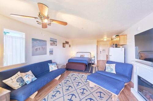 a living room with a blue couch and a refrigerator at Sandpiper Approach in Long Beach