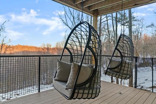 two hanging chairs on a porch with a view of the water at Adamina Canyon Luxurious, Canyon View 5BR 3BTH- 6 in Rockbridge