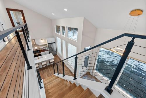 a staircase with a glass railing in a house at Adamina Canyon Luxurious, Canyon View 5BR 3BTH- 6 in Rockbridge