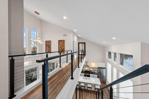 a staircase in a house with white walls and wooden floors at Adamina Canyon Luxurious, Canyon View 5BR 3BTH- 6 in Rockbridge