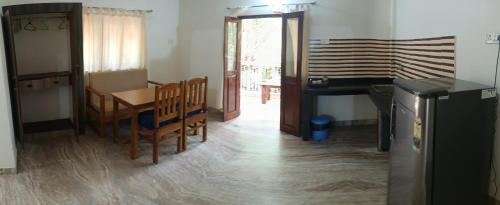 a living room with a table and a piano at Jacinta's - By the beach - Cruz's place in Calangute
