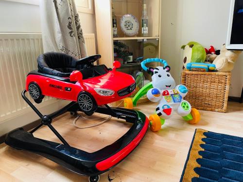 a toy car and a toy cow in a room at Modern Home in Peaceful Area with Private Lawn, BBQ & Free Parking in Kauniainen