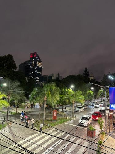 a city street at night with people walking and cars at El lapacho 3 in Santiago del Estero