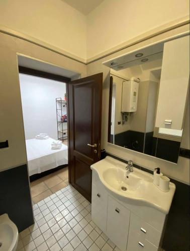 a bathroom with a sink and a mirror at Cozy Colosseo in Rome