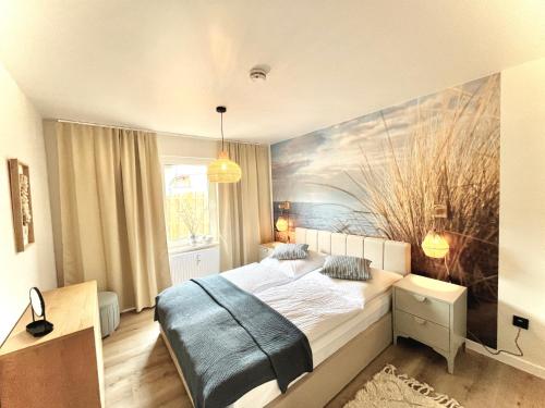 a bedroom with a bed with a painting on the wall at Bungalow Blue Sea im Green Village Benz in Benz