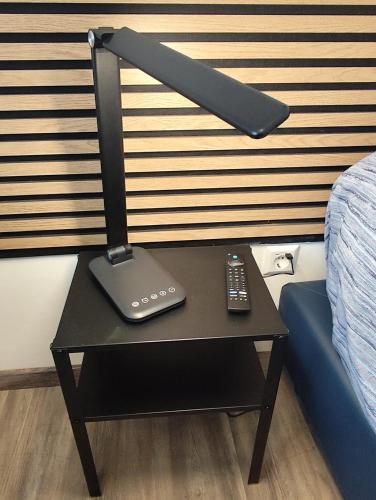 a lamp on a table next to a bed at Biella Living in Biella