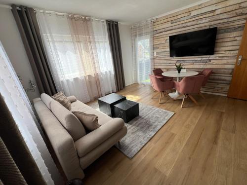 a living room with a couch and a table at Ferienwohnung Ferlach TOP1 in Ferlach