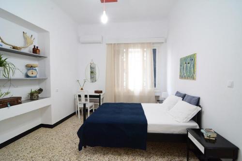 a bedroom with a bed and a table in a room at The SPiTi Project 33 in Kavala