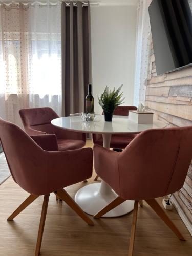 a dining room with a white table and chairs at Ferienwohnung Ferlach TOP1 in Ferlach
