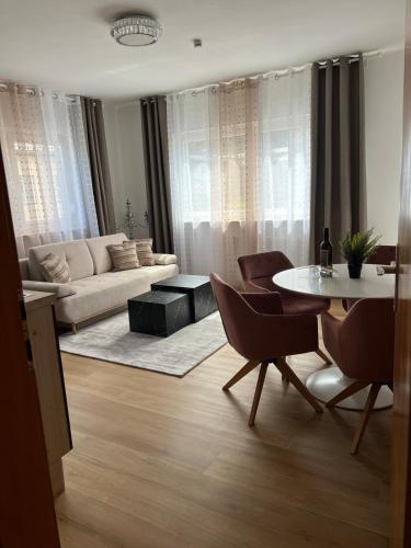 a living room with a couch and a table and chairs at Ferienwohnung Ferlach TOP1 in Ferlach