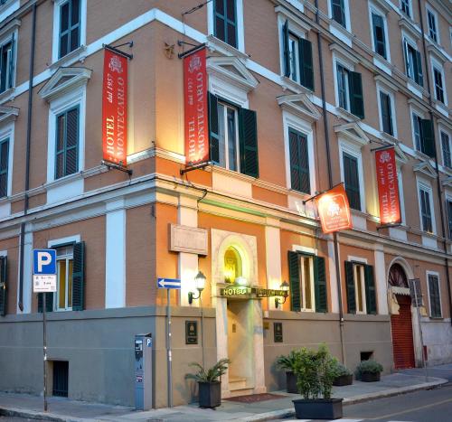 a building with red signs on the side of it at Hotel Montecarlo in Rome