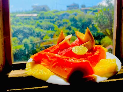a plate of fruit sitting on a window sill at The Lake Frost in Nuwara Eliya