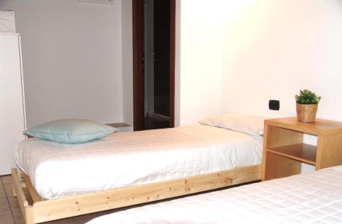 a bedroom with two beds and a night stand at Giulia Attic in Bulciago