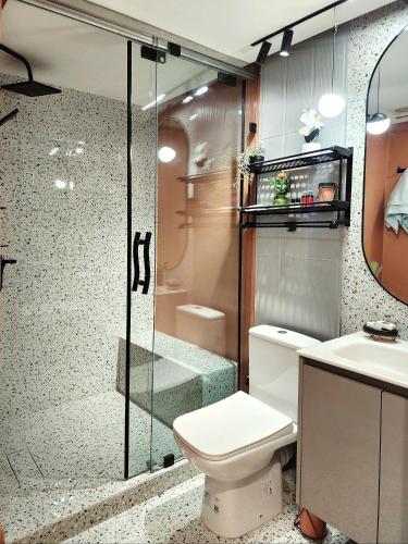 a bathroom with a toilet and a shower and a sink at appartement de luxe réservée aux familles in Meknès