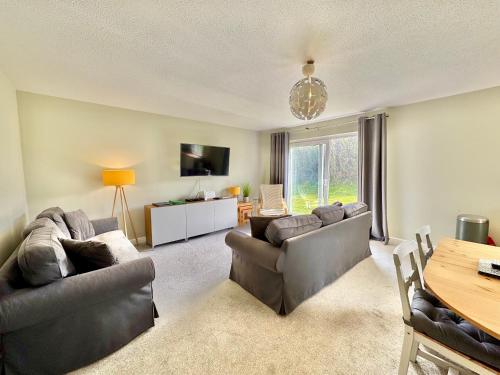 a living room with two couches and a table at 7 Isallt Lodges-3 bed-Ground Floor-Outside seating in Trearddur