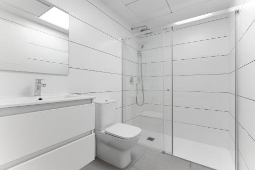 a white bathroom with a toilet and a shower at Valentino Golf II Luxury in Orihuela