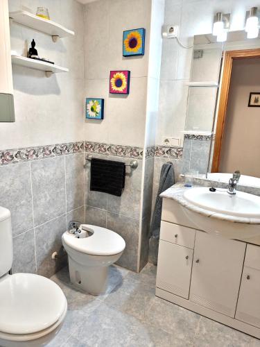 a bathroom with a toilet and a sink at Exclusive Penthouse Pool & Beach - Lovely for families - Los Pinos Residential in El Campello