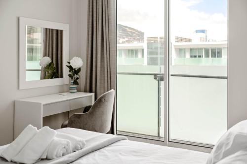 a hotel room with a bed and a window at SeaSide Serenity in Funchal