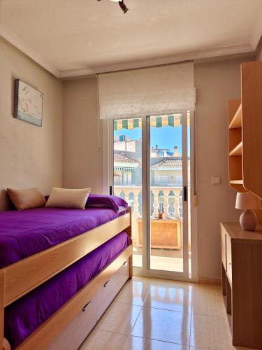 a bedroom with a bed and a balcony at Exclusive Penthouse Pool & Beach - Lovely for families - Los Pinos Residential in El Campello