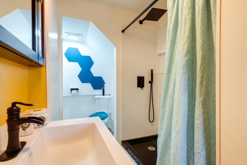 a bathroom with a sink and a shower at Walk to Trails Artsy Mtn-View Getaway in Vernon! in Vernon