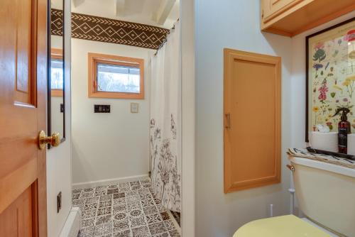 a bathroom with a toilet and a shower at Deck, Mountain Views Colorful Retreat in Vernon! in Vernon