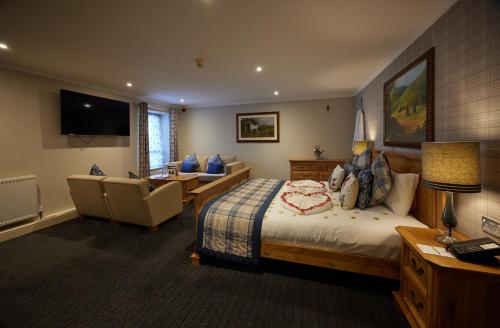 a hotel room with a bed and a living room at Stone House Hotel ‘A Bespoke Hotel’ in Stone
