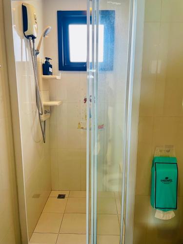 a shower with a glass door in a bathroom at The base Condo luxury 2 bed 2 bathroomby Numam in Pattaya
