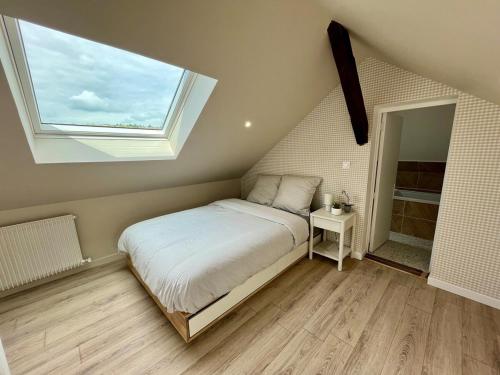 une chambre avec un lit avec une grande fenêtre dans l'établissement Le Jasmin, à Rouen