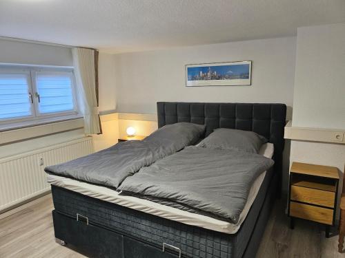 ein großes Bett in einem Zimmer mit Fenster in der Unterkunft Aurora Apartment in Essen in Essen