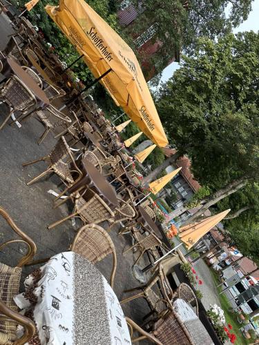 a group of chairs and umbrellas at a tables and chairsktop at Hotel-Café-Restaurant Parkhaus in Altenau