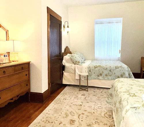 a bedroom with a bed and a dresser and a window at Royal Hotel Sydney in Sydney