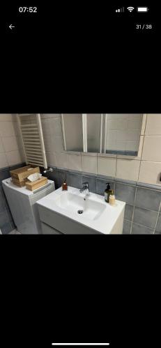 a bathroom with a white sink and a toilet at Casa Ale in Dolceacqua