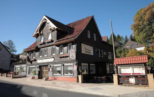 a black building on the side of a street at Hotel-Café-Restaurant Parkhaus in Altenau