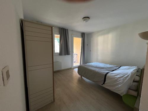 Ένα ή περισσότερα κρεβάτια σε δωμάτιο στο Appartement au coeur du Domaine