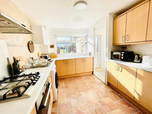 a kitchen with a stove and a counter top at Double room in 3 bedroom house in Edinburgh