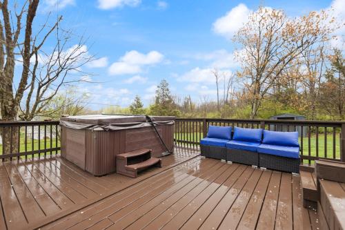 a deck with a bench and a hot tub at The Kentucky Bluegrass Retreat in Frankfort