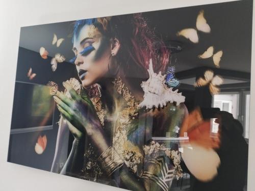 a painting of a woman with butterflies on a wall at Lena Exclusive in Bihać