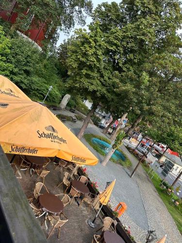 a group of chairs and an umbrella and a pool at Hotel-Café-Restaurant Parkhaus in Altenau