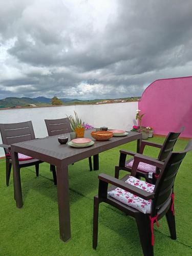 a picnic table with two chairs and a table with at Apartamento La Bella Vista ATBA00361 in Zafra
