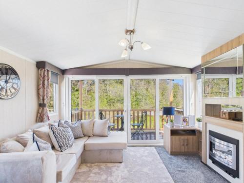a living room with a couch and a fireplace at Riverside Lodge in Hawick