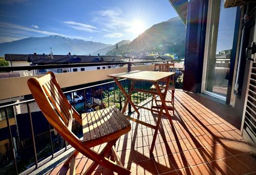 a table and chairs on a balcony with a view at Casa Viola - Near the beach in Domaso