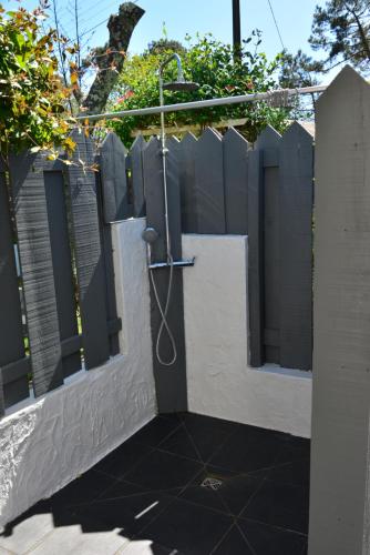 a fence with a shower in the side of a house at La Villa du Grand Large in Biscarrosse