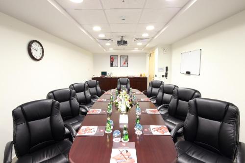 a conference room with a long table and chairs at Ibis Riyadh Olaya Street in Riyadh