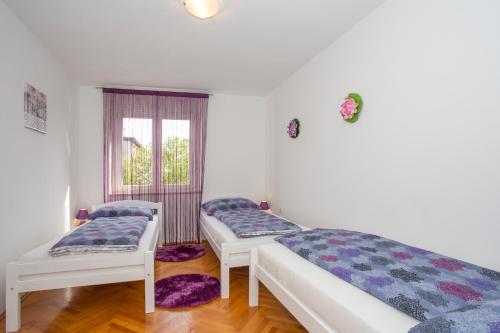 a room with two beds and a window at Dream Apartment Rijeka 3 in Rijeka