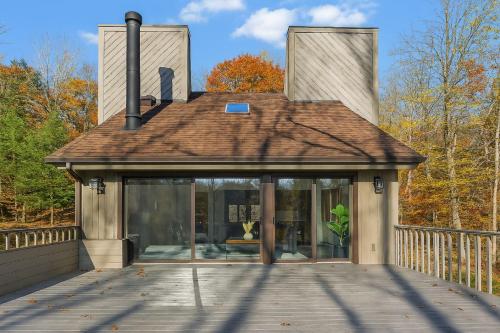 a house with glass doors and a roof at Drift Haus 4.5BR Mountain Lodge in Windham