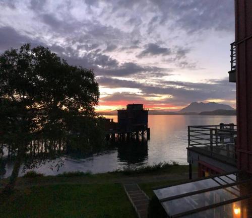 a view of a body of water at sunset at Tofino Eco Waterfront Condo in Tofino