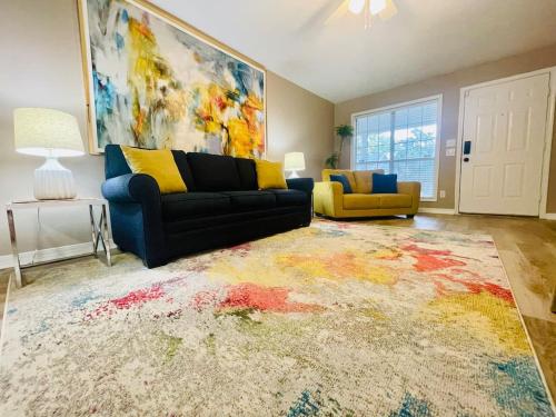 a living room with a couch and a rug at Eastgate 14A beautiful townhouse in Hammond