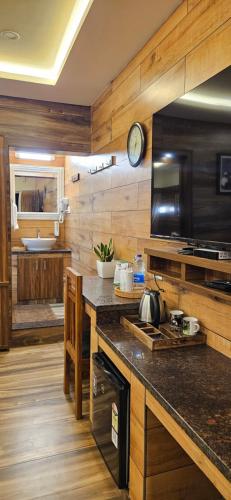 a kitchen with wooden walls and a counter top at S & B Dreams House in Munnar